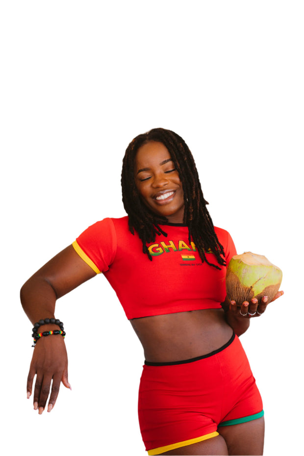 Vibrant red crop top and matching shorts set, inspired by Ghanaian culture, featuring bold patterns and colors that celebrate heritage and summer fashion.