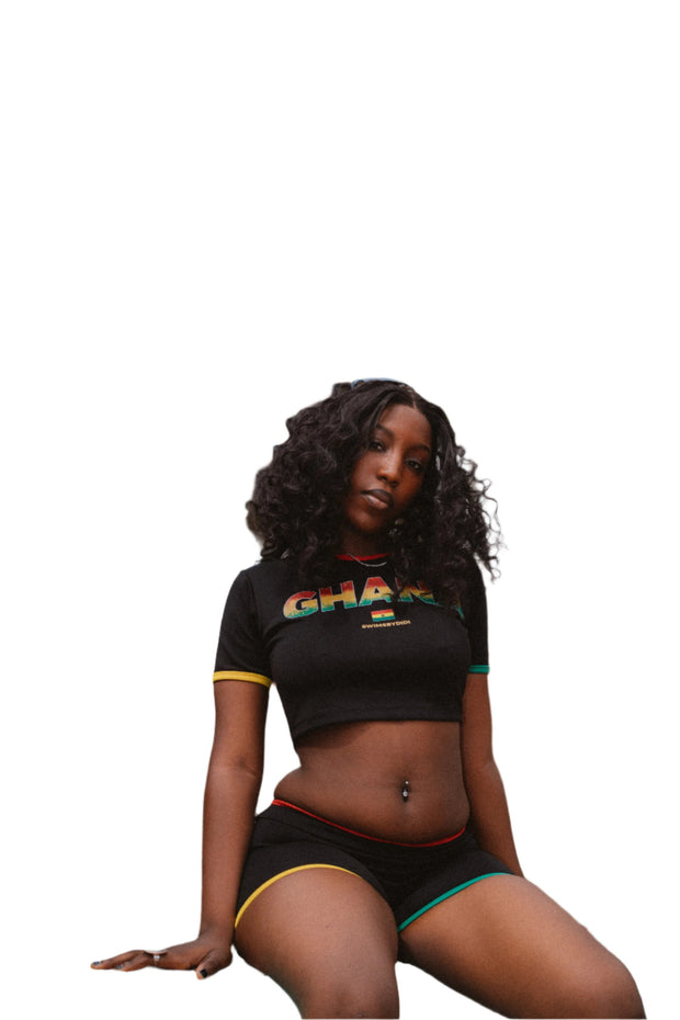 Stylish black two-piece set featuring a Ghanaian-inspired crop top and matching shorts, adorned with vibrant patterns that celebrate West African culture and contemporary fashion
