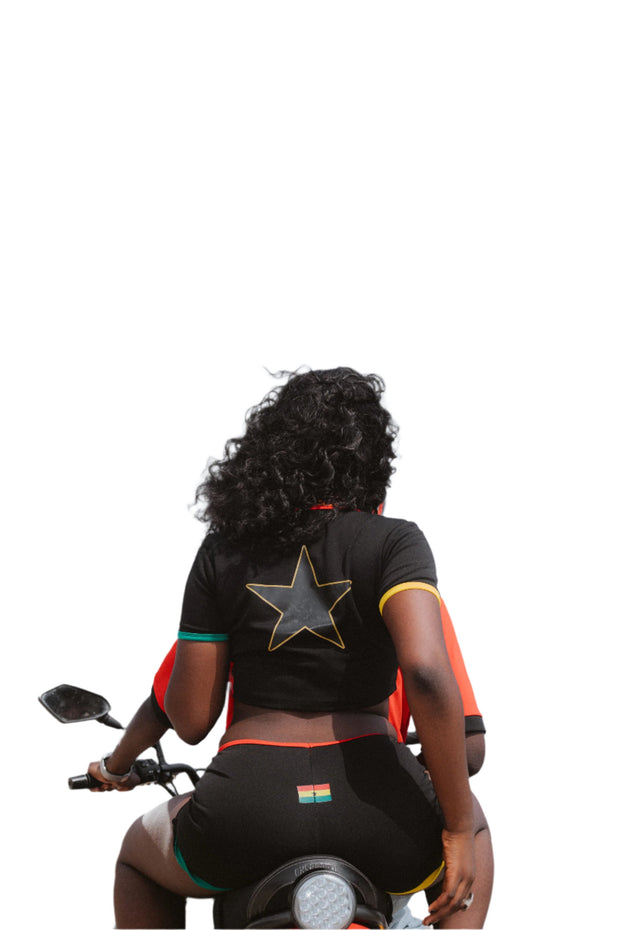 Stylish black two-piece set featuring a Ghanaian-inspired crop top and matching shorts, adorned with vibrant patterns that celebrate West African culture and contemporary fashion